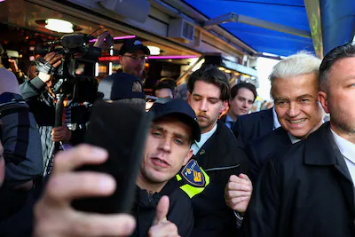 a-person-takes-a-selfie-with-dutch-party-for-freedom-pvv-leader-geert-wilders-as-wilders-attends-a-m.webp