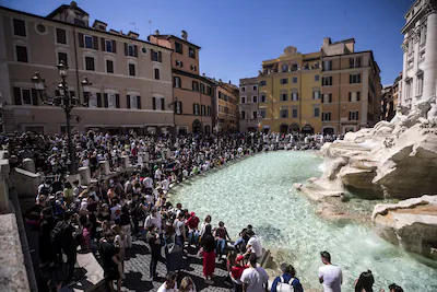 epa09892798-tourists-visit-the-trevi-fountain-in-the-center-of-rome-during-the-easter-holidays-in-ro.webp