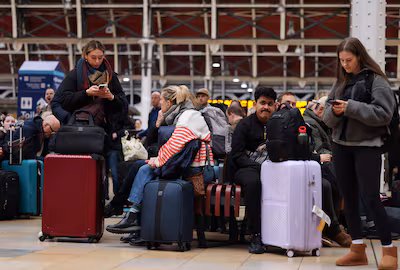 epa12576807-heathrow-bound-travelers-wait-to-board-the-heathrow-express-after-long-delays-in-london.avif