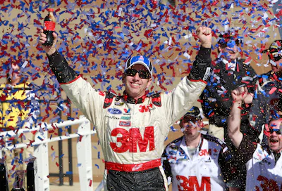 file-greg-biffle-celebrates-in-victory-lane-after-winning-the-nascar-sprint-cup-series-auto-race-at.webp