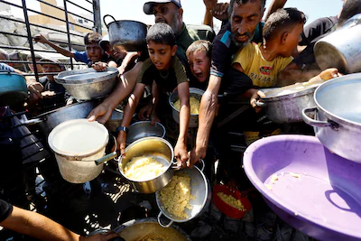 file-photo-palestinians-wait-to-receive-food-from-a-charity-kitchen-after-the-global-hunger-monitor.webp