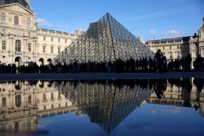 file-photo-people-stand-outside-the-louvre-museum-after-french-police-arrested-suspects-in-the-louvr.webp