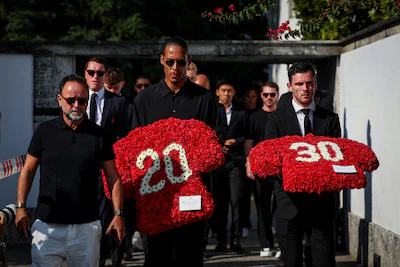 liverpool-s-captain-virgil-van-dijk-and-liverpool-s-player-andrew-robertson-arrive-on-the-day-of-the.webp