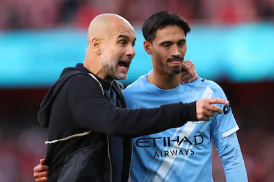 london-england-september-21-pep-guardiola-the-head-coach-manager-of-manchester-city-with-tijjani-rei.webp