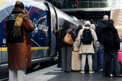 people-stand-next-to-a-eurostar-train-at-gare-du-nord-station-after-eurostar-announced-a-power-suppl.webp