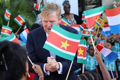 the-netherlands-king-willem-alexander-greets-people-among-surinamese-and-dutch-flags-during-an-offic.jpeg