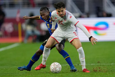 tunisia-s-sebastian-tounekti-right-is-challanged-by-tanzania-s-alphonse-mabula-during-the-africa-cup.webp