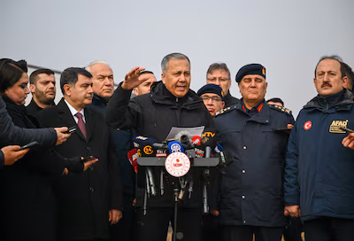 turkish-interior-minister-ali-yerlikaya-speaks-to-the-media-as-he-visits-the-crash-site-of-a-jet-car.avif