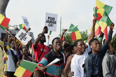 young-people-and-supporters-of-benin-president-patrice-talon-hold-benin-flags-and-placards-reading-n.jpeg