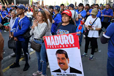 a-demonstrator-displays-a-sign-with-an-image-of-u-s-deposed-venezuelan-president-nicolas-maduro-duri.webp