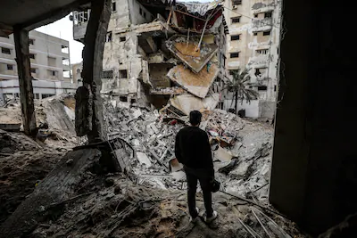 a-palestinian-checks-the-damaged-buildings-following-israeli-airstrikes-in-gaza-city-on-january-31-2.webp