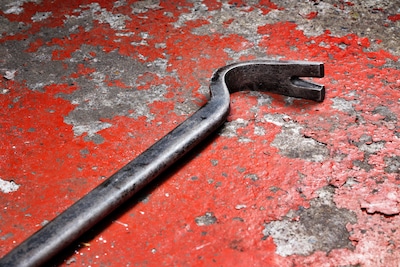 an-old-crowbar-on-a-red-background.jpeg
