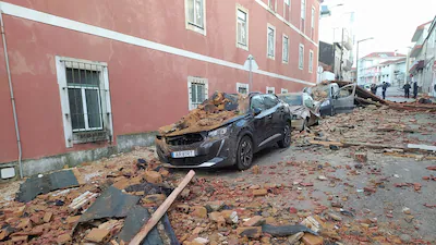 cars-are-seen-damaged-after-a-building-s-roof-collapsed-on-them-during-the-passage-of-storm-kristin.webp