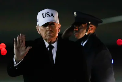 file-president-donald-trump-waves-after-arriving-on-air-force-one-from-florida-jan-11-2026-at-joint.webp