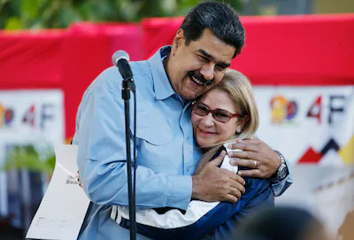 file-venezuela-s-president-nicolas-maduro-hugs-first-lady-cilia-flores-during-an-event-at-bolivar-sq.webp
