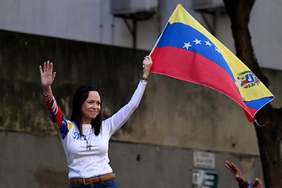 files-venezuelan-opposition-leader-maria-corina-machado-waves-a-national-flag-during-a-protest-calle.jpeg
