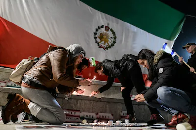 israelis-light-candles-next-to-a-lion-and-sun-pre-iranian-revolution-flag-of-iran-as-they-rally-agai.webp
