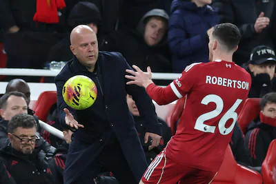 liverpool-s-dutch-manager-arne-slot-throws-the-ball-to-liverpool-s-scottish-defender-26-andrew-rober.webp