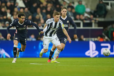 newcastle-s-harvey-barnes-center-is-challenged-by-psv-s-anass-salah-eddine-left-during-the-champions.webp