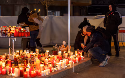 people-visit-a-makeshift-memorial-outside-the-le-constellation-bar-after-a-deadly-fire-and-explosion.avif