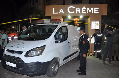 police-work-a-crime-scene-after-two-men-opened-fire-at-the-cafe-la-creme-located-in-the-tourist-area.avif