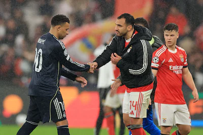 real-madrid-s-french-forward-10-kylian-mbappe-shakes-hands-with-benfica-s-greek-forward-14-vangelis.webp