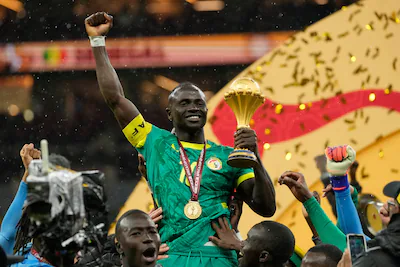 senegal-s-sadio-mane-holds-the-trophy-after-winning-the-africa-cup-of-nations-final-soccer-match-aga.webp