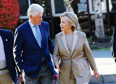 democratic-presidential-nominee-hillary-clinton-talks-with-her-husband-and-former-president-bill-cli.webp